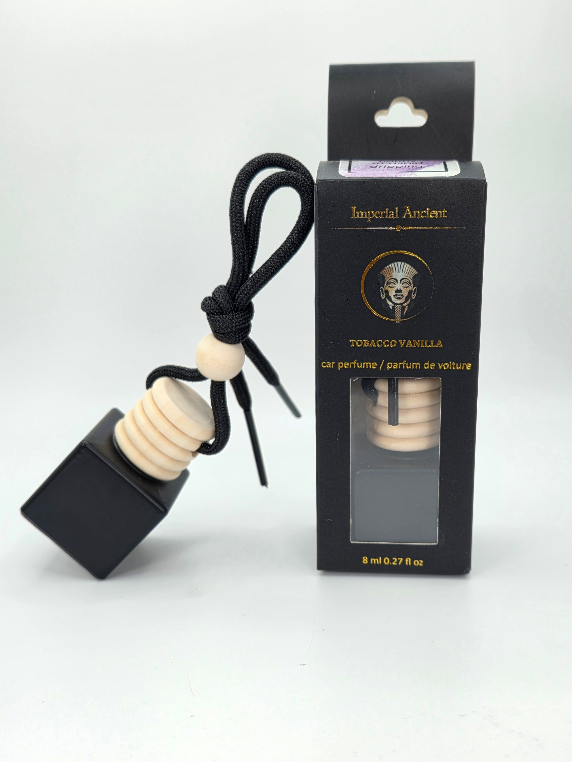 Imperial Ancient hanging car air freshener in Tobacco Vanilla scent, with wooden cap and black string, displayed beside branded black packaging box