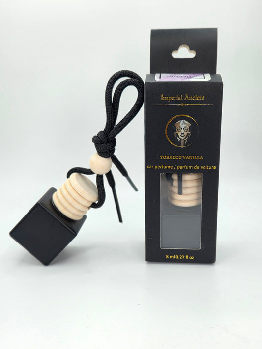 Imperial Ancient hanging car air freshener in Tobacco Vanilla scent, with wooden cap and black string, displayed beside branded black packaging box