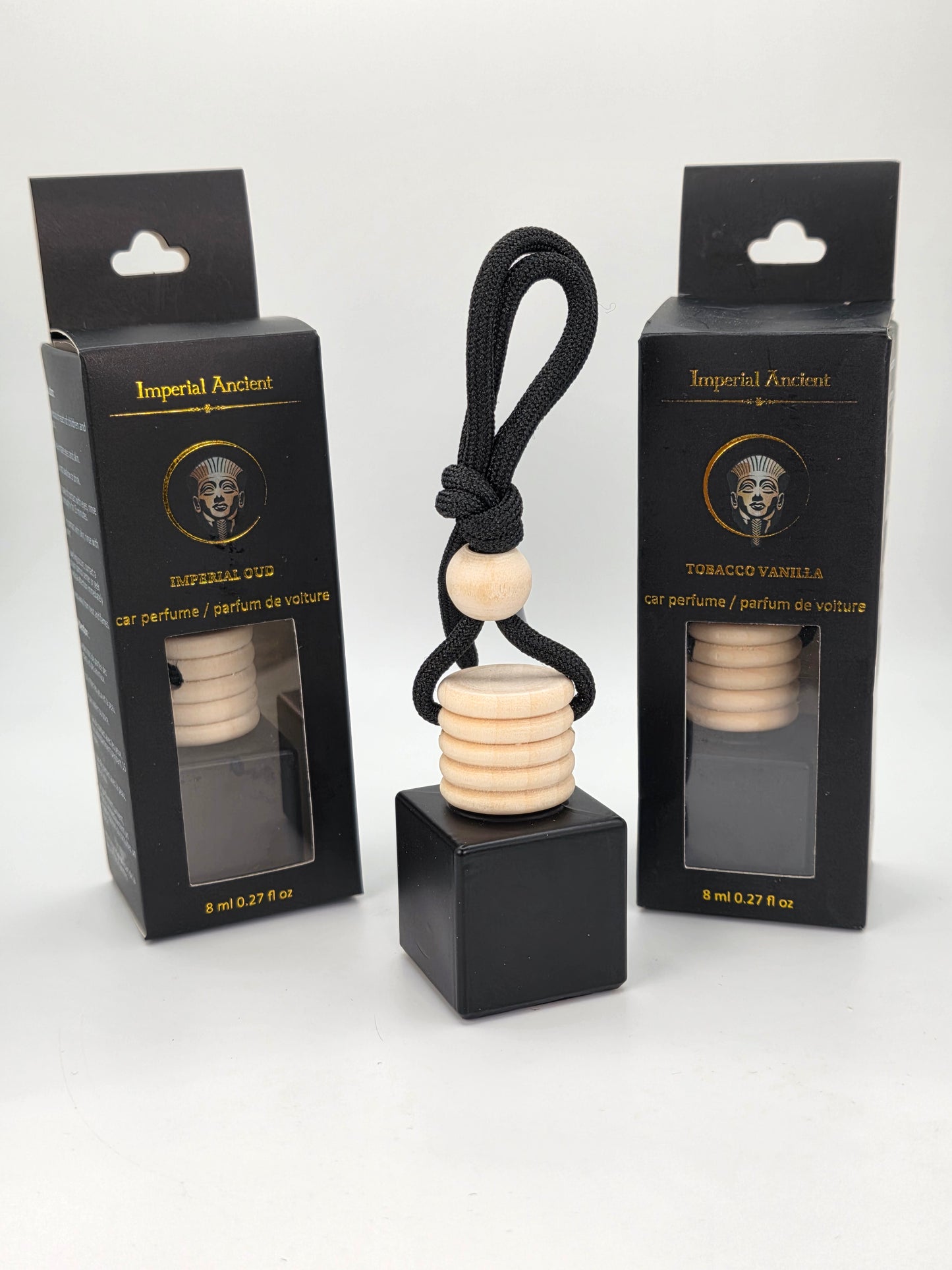 Imperial Undeniable Car Air Freshener – Black square bottle with wooden cap and black cord, displayed with two premium black and gold retail boxes