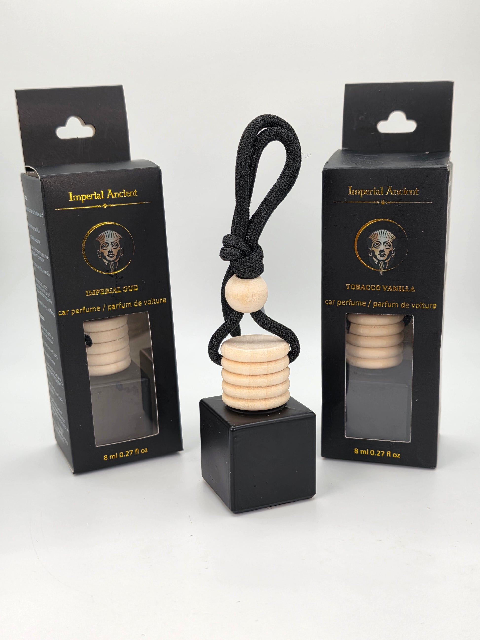 Imperial Undeniable Car Air Freshener – Black square bottle with wooden cap and black cord, displayed with two premium black and gold retail boxes